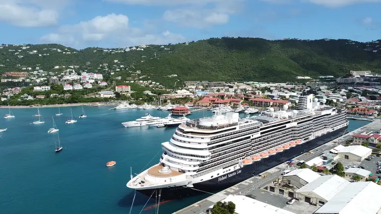 Aerial view of a cruise ship docked in a harbor town